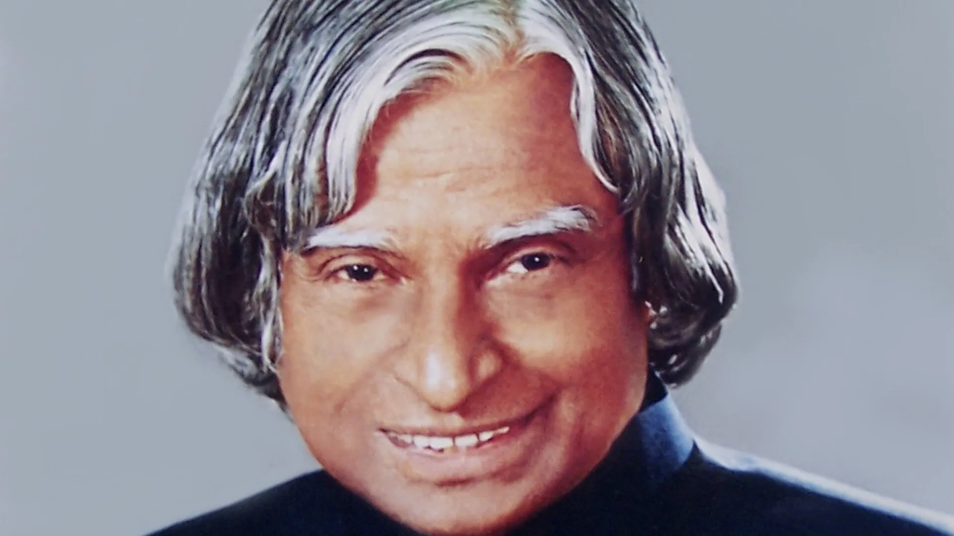 Official portrait of Dr A.P.J. Abdul Kalam, smiling, with his trademark swept-back silver hair