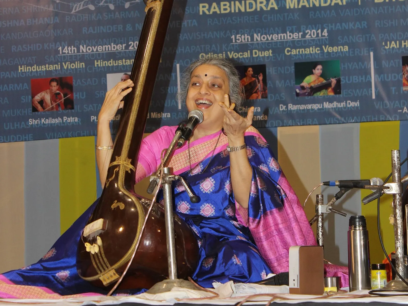 Ashwini Bhide Deshpande singing on stage with a tanpura