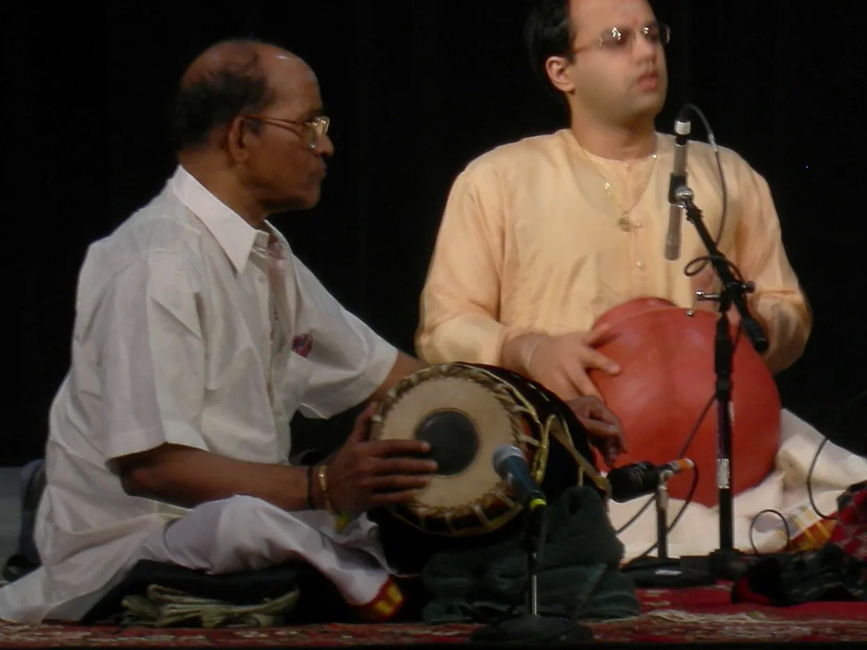 Guruvayur Dorai playing the mridangam at a concert