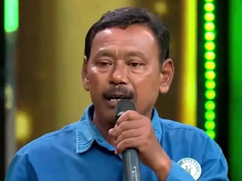 Karimul Hak speaking into a microphone on a stage