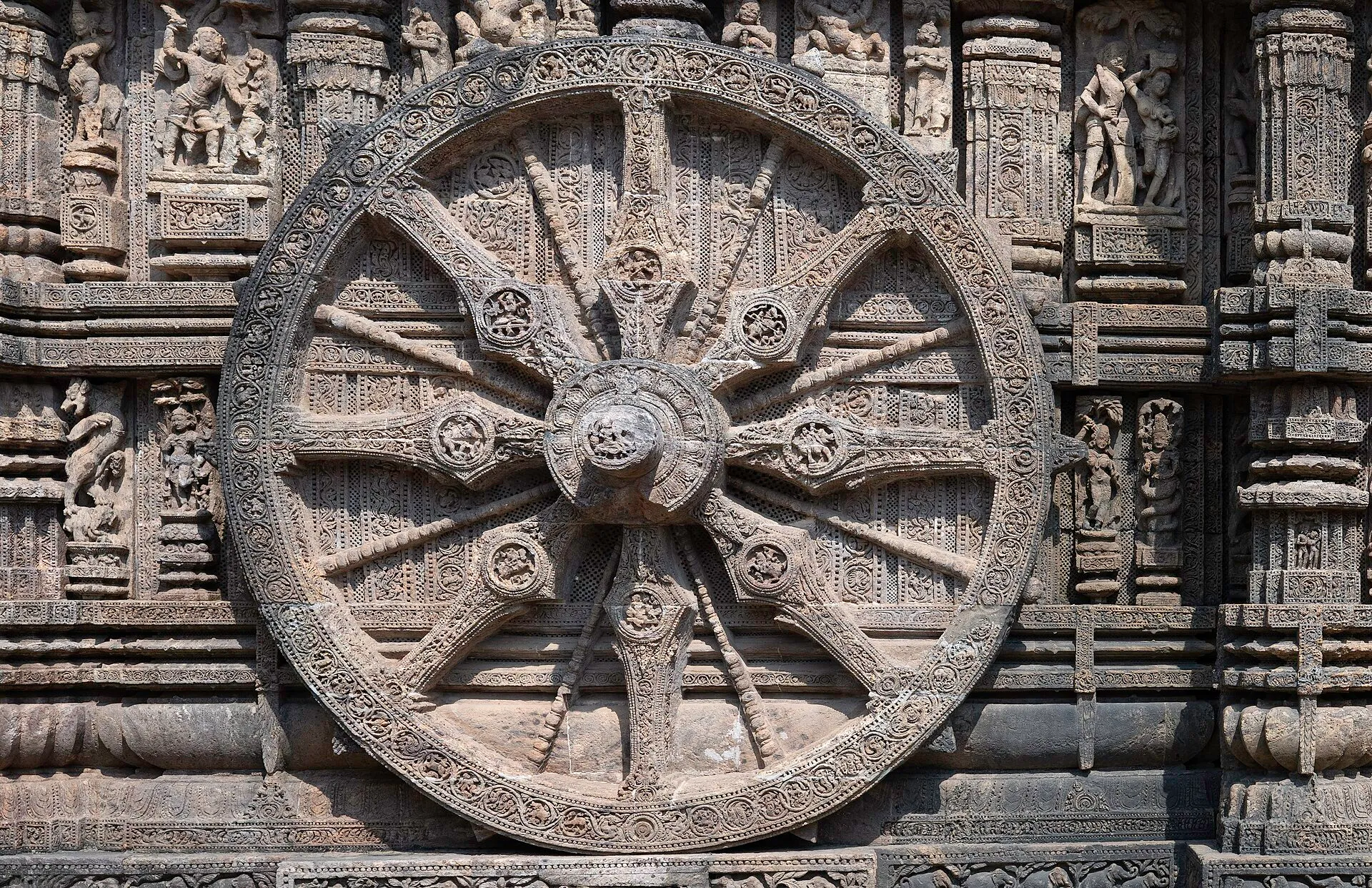 One of the great carved stone wheels of the Konark Sun Temple, with figures carved on its spokes and rim