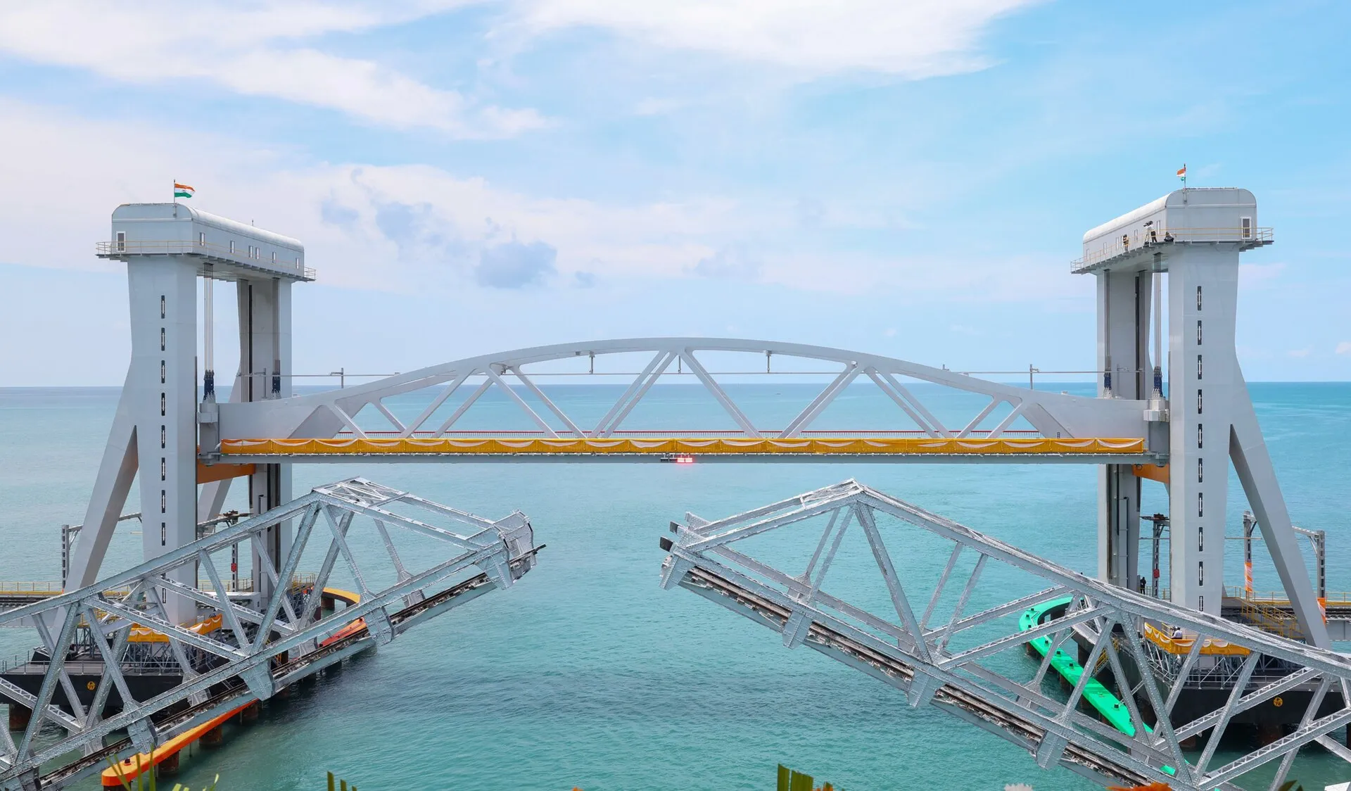 The New Pamban Bridge with its vertical-lift span between two towers, beside the old bridge's open Scherzer span